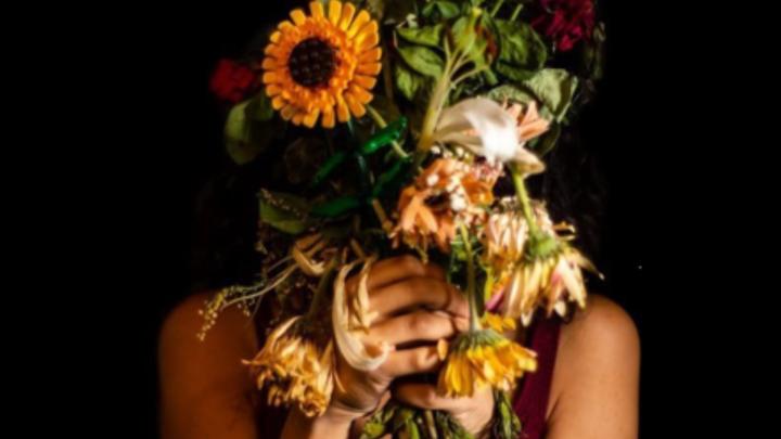 Particolòare di foto di scena, dal sitovisitvalsesiavercelli.it Donna con mazzo di fiori davanti al viso