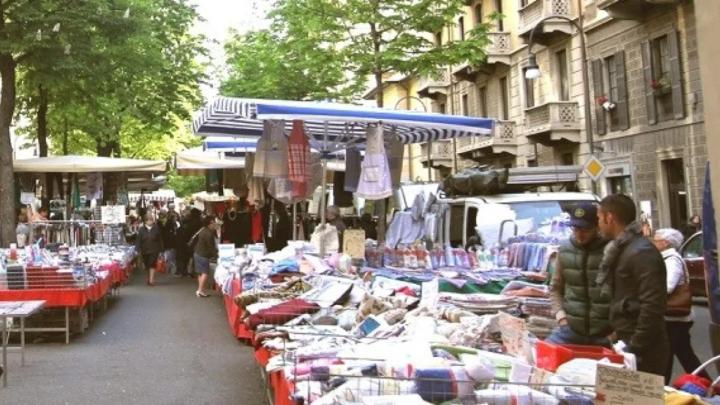 Viale con bancarelle di mercato e avventori